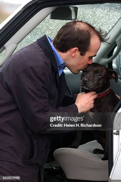 Ben Wilson kisses his dog Buddy <cq> outside the Denver Municipal Animal Shelter <cq> at 666 S. Jason Street <cq> Buddy is an English Staffordshire...