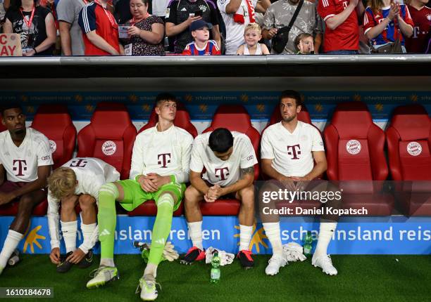 Harry Kane of Bayern Munich looks on from the bench with his teammates during the DFL Supercup 2023 match between FC Bayern München and RB Leipzig at...