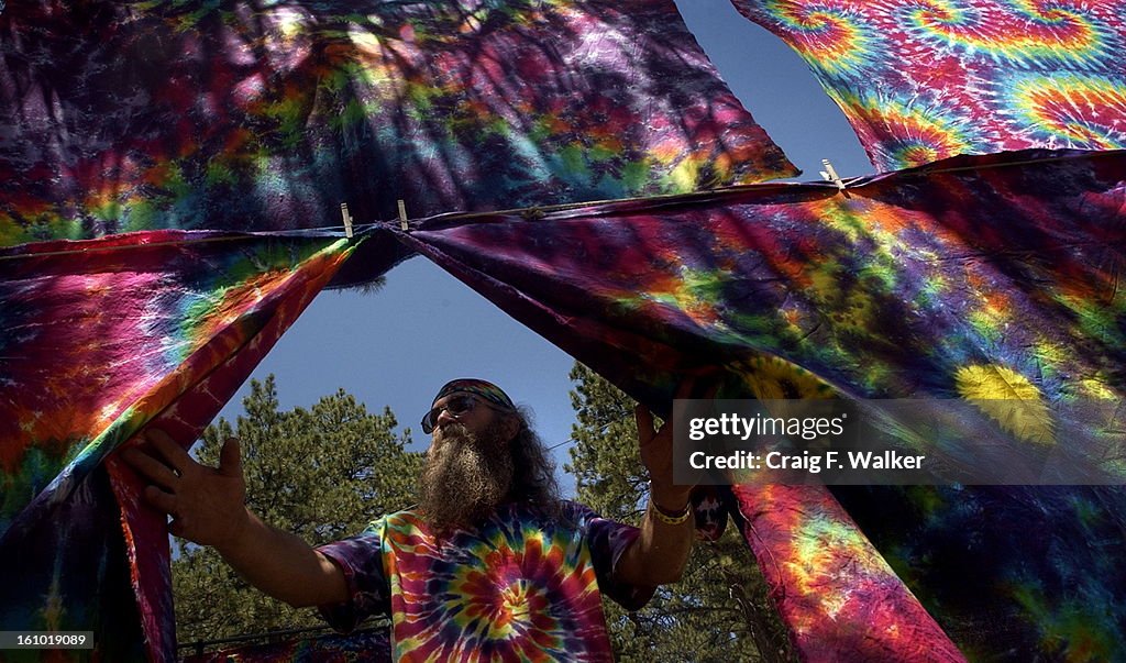 MORRISON, CO, JULY 8, 2003- _Tim <cq> Dods <cq> of Tulsa, OK is surrounded by his tie-dyed tapestry while taking in the view at Chief Hosa Campground <cq>. Dods was in the area to attend the Dead's "Summer Getaway" tour at Red Rocks Amphitheatre. The vete