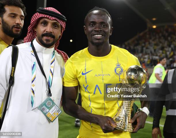 Sadio Mane of Al Nassr poses for a photo with the Arab Club Champions Cup trophy after the team's victory in the Arab Club Champions Cup Final...