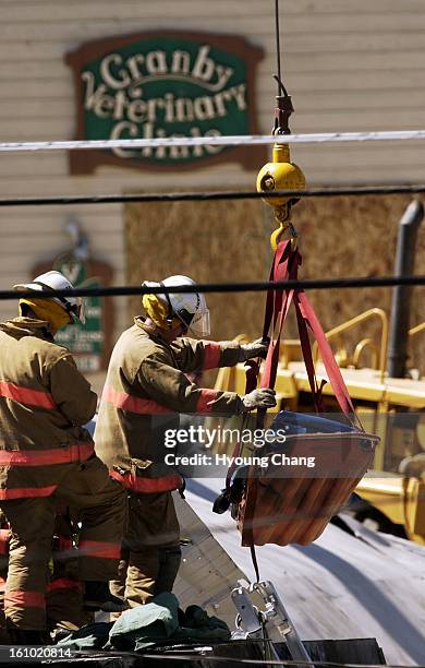 Firefighters move the body of Marvin Heemeyer by using a clane from the bulldozer at Gambles store, Granby on Saturday morning.