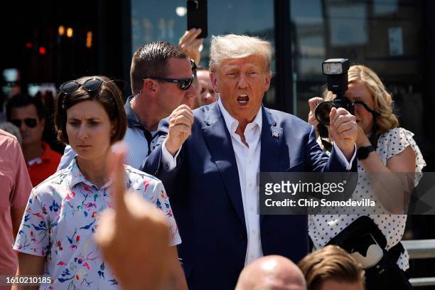 Former U.S. President Donald Trump acknowledges supporters as the visits the Iowa State Fair on August 12, 2023 in Des Moines, Iowa. Republican and...