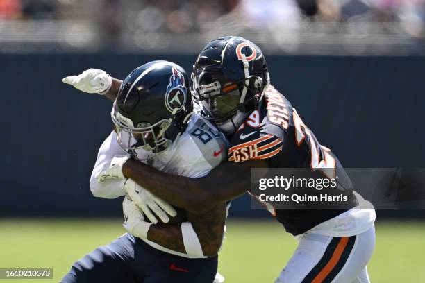 Tyrique Stevenson of the Chicago Bears tackles Tre'Shaun Harrison of the Tennessee Titans in the second quarter during a preseason game at Soldier...