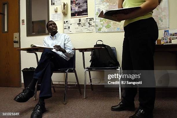 Elijah Gai, left, one of the Lost Boys of Sudan, who lives in Denver, goes over vocabulary words, Wednesday June 15 during class Red Rocks Community...