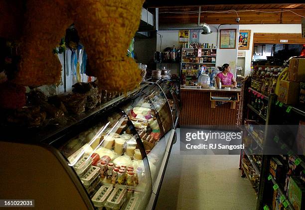 Maria<CQ> Venegas<CQ> 22, works at the counter Wednesday, June 22 at Tortilleria Los Comales in Greeley. The store is a popular place for Latinos to...