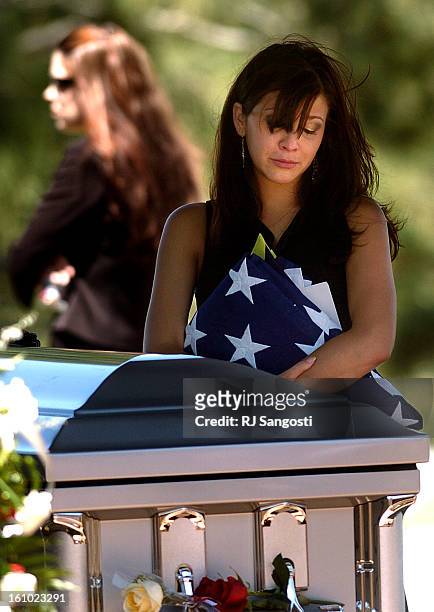Tiffany<CQ> Dietz<CQ>, younger sister of Danny Dietz a Navy SEAL killed two weeks ago in Afghanistan, spends a moment with her brother after a burial...