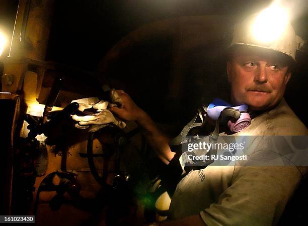 Rick<CQ> Ernst<CQ>, a foreman at the Cotter Corp. Uranium Mine northwest of Naturita, takes off his resperator to discuss the mine while sitting on...