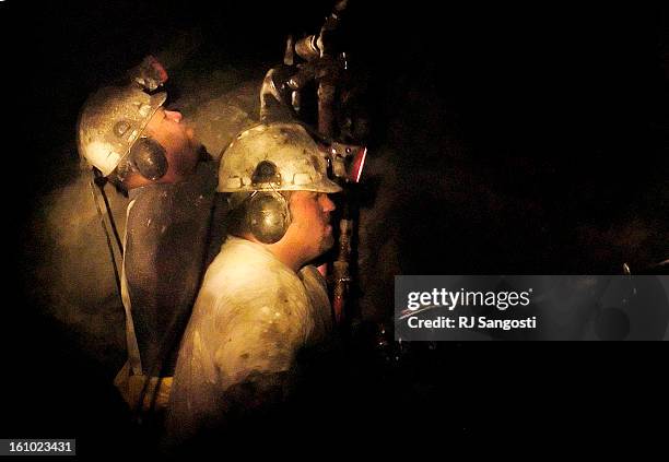 Jerry<CQ> Kettel<CQ>, left, and Ron<CQ> Ernst<CQ> drillTuesday, July 19 about 600 feet deep in the Cotter Corp. Uranium Mine located northwest of...
