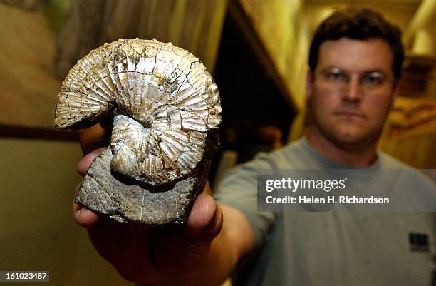 Kirk Johnson, Curator of Paleontolgy and Head of the Department of Earth Sciences at the Denver Museum of Nature and Science, holds an Ammonite, or a...