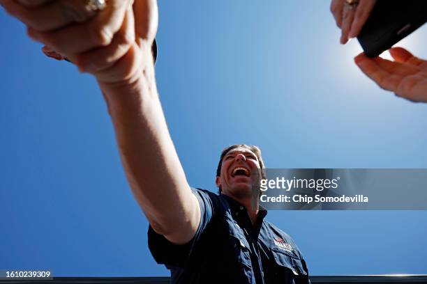 Florida Governor and Republican presidential candidate Ron DeSantis shakes hands with supporters at the conclusion of one of Iowa Governor Kim...