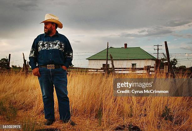 Conejos, COLORADO in the SAN LUIS VALLEY 7/18/02 Demetrio Valdez stands in the dried grass outside the adobe home where four generations of the...