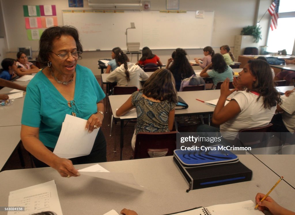 DENVER, CO . TUESDAY, AUGUST 17 , 2004. The Rachel Bassette Noel Middle School is filled to it's enrollment capacity for the third year in a row. In a classroom with 33 students, 6th grade math teacher Margaret King-Shearron <CQ> passes out work for the s