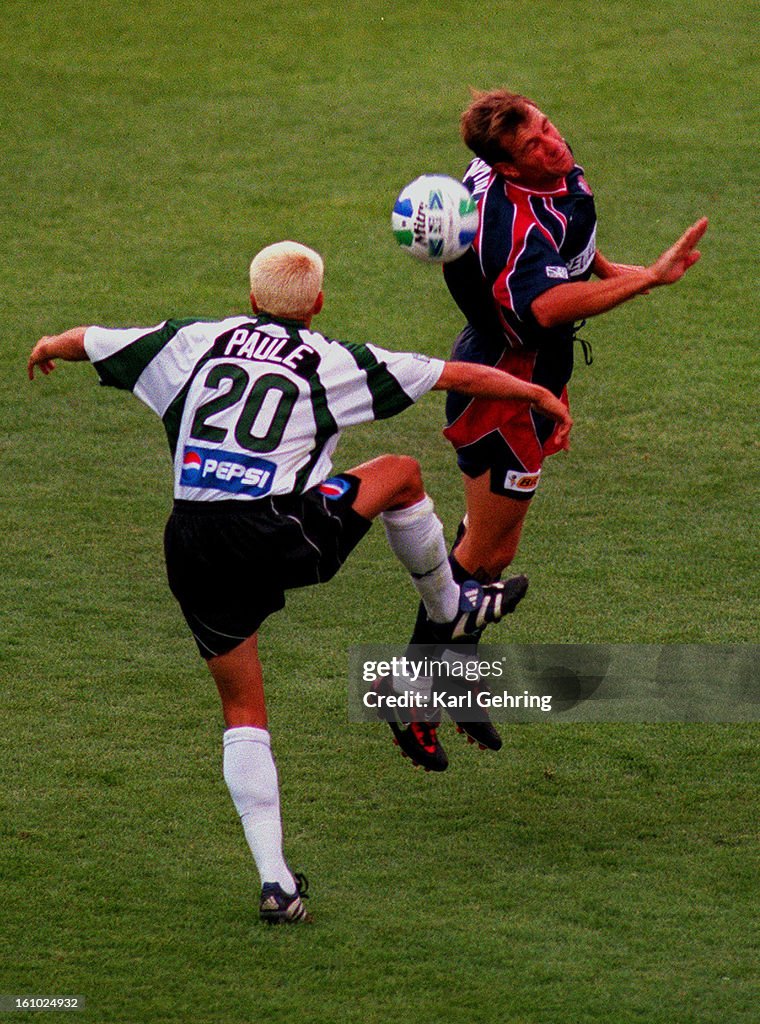 Colorado midfielder Ross Paule attempted to defend against a header from New England 's Ivan McKinley in the first half of MLS action in Denver Saturday July 11, 1998.