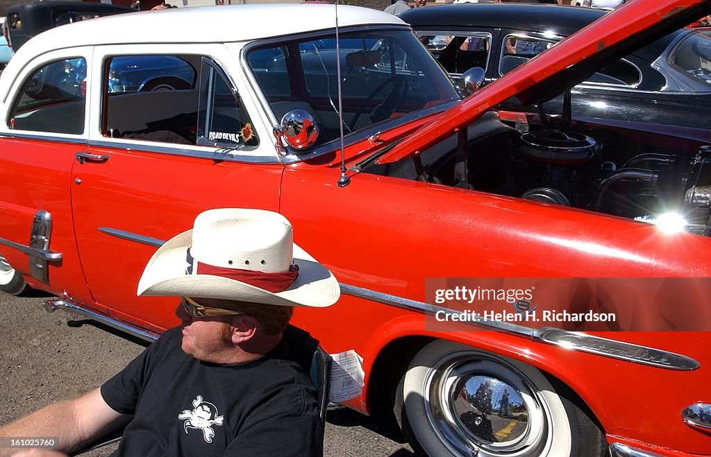 Aaron Hoofmeyer of Arvada sits in front of his prized possession his 1953 Custom Line Ford. He took part in the StreamLine Hot Rod Car show at 8th ave and Kalamath street. There were hot rods, rat rods, street rods, kit cars and even motorcycles at the sh