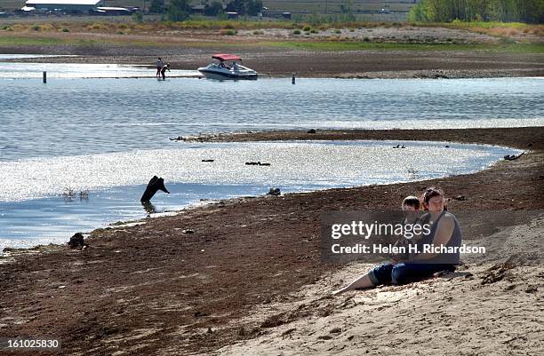 Smattering of people still enjoy what is left of the water at Standley Lake in Westminster. At it's fullest the lake is about 97 feet deep. Currently...