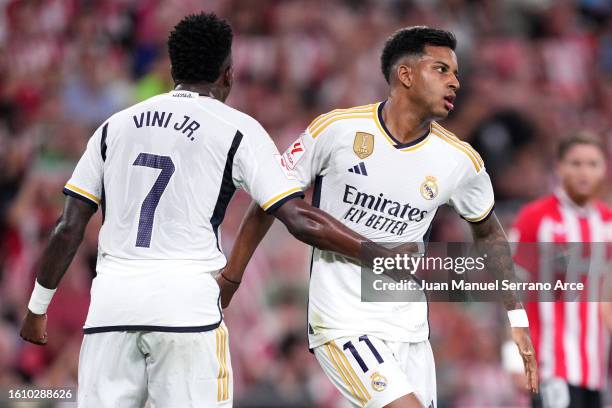 Vinicius Junior of Real Madrid interacts with teammate Rodrygo during the LaLiga EA Sports match between Athletic Club and Real Madrid CF at Estadio...