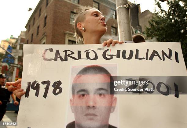 Protester holds a sign of the Italian anti-global activist Carlo Giuliani who was killed by police during protests at the G8 conference August 20,...