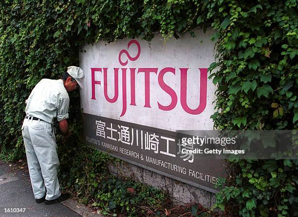 The Fujitsu logo is on display in front of the company''s headquarters for Fujitsu Kawasaki August 24, 2001 in Tokyo, Japan. The company announced a...