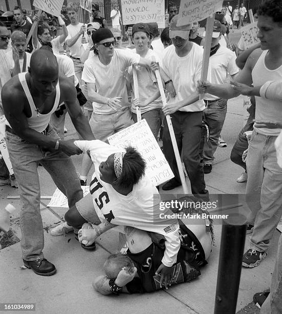 An African American woman save a nazi from serious harm at a protest in Ann Arbor Mi. June 22, 1996. A dozen members of a self-anointed and unwelcome...