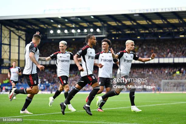 Bobby De Cordova-Reid of Fulham celebrates with teammates after scoring the team's first goal during the Premier League match between Everton FC and...