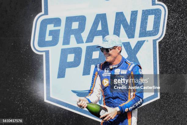 Scott Dixon driver of the PNC Bank Chip Ganassi Racing Honda celebrate by spraying champagne in victory lane after winning the NTT IndyCar Series...