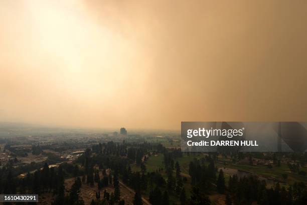 Smoke from the McDougall Creek wildfire envelops Kelowna, British Columbia, Canada, on August 18, 2023. Wildfires bore down on Canada's Yellowknife...