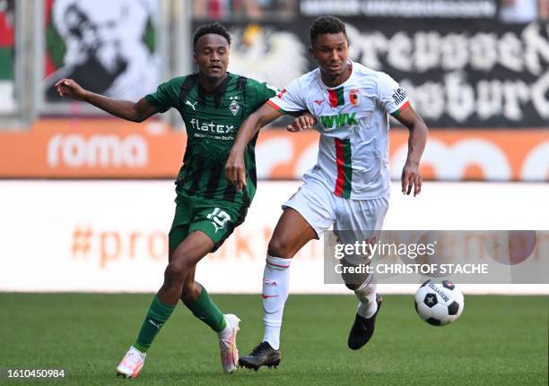 Moenchengladbach's French midfielder Nathan Ngoumou and Augsburg's German defender Felix Uduokhai vie for the ball during German first division...