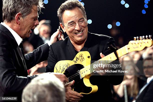 Musician and honoree Bruce Springsteen participates in the auction with musician David Foster during MusiCares Person Of The Year Honoring Bruce...