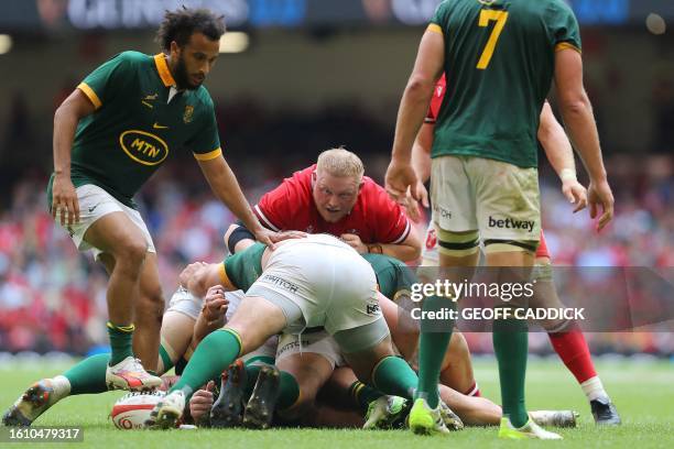 Wales' prop Corey Domachowski reacts as players try to grab the ball during the pre-World Cup Rugby Union match between Wales and South Africa at...