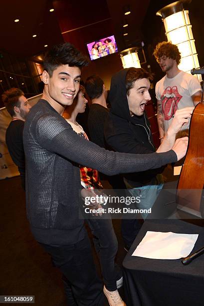 Singers Siva Kaneswaran and Tom Parker of The Wanted pose backstage at the GRAMMYs Dial Global Radio Remotes during The 55th Annual GRAMMY Awards at...