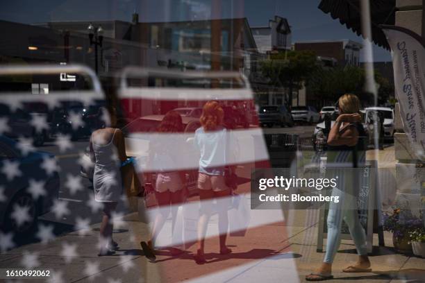 American flag themed beach chairs for sale at a store in Ocean City, New Jersey, US, on Friday, Aug. 18, 2023. Surveys suggest that despite cooling...