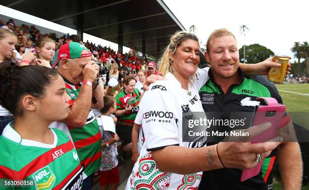 Rabbitohs captain Michael Crocker poses with a fan for a photo before the NRL trial match between the South Sydney Rabbitohs and the Papua New Guinea...