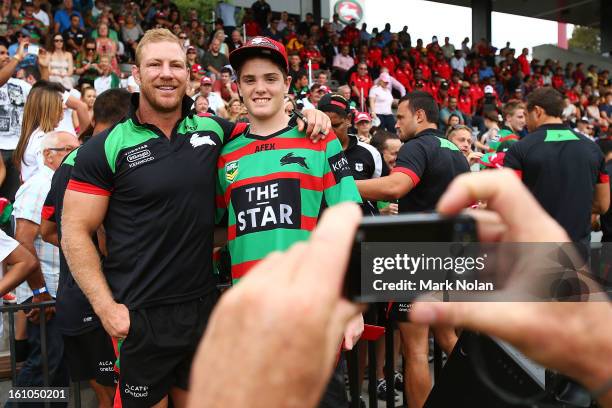 Rabbitohs captain Michael Crocker poses with a fan for a photo before the NRL trial match between the South Sydney Rabbitohs and the Papua New Guinea...