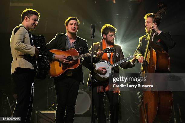 Musicians Ben Lovett, Marcus Mumford, 'Country' Winston Marshall and Ted Dwane of Mumford & Sons perform onstage at MusiCares Person Of The Year...