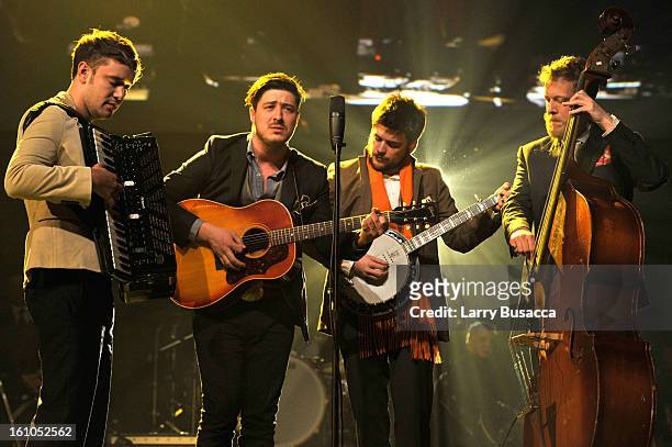 Musicians Ben Lovett, Marcus Mumford, 'Country' Winston Marshall and Ted Dwane of Mumford & Sons perform onstage at MusiCares Person Of The Year...