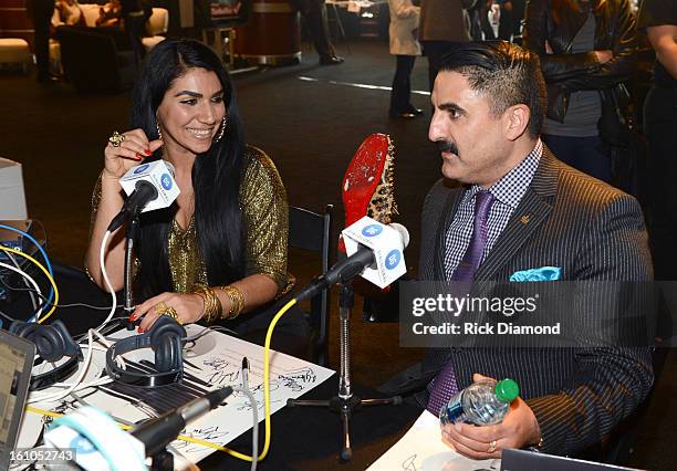 Asa Soltan Rahmati and Reza Farahan interview backstage at the GRAMMYs Dial Global Radio Remotes during The 55th Annual GRAMMY Awards at the STAPLES...