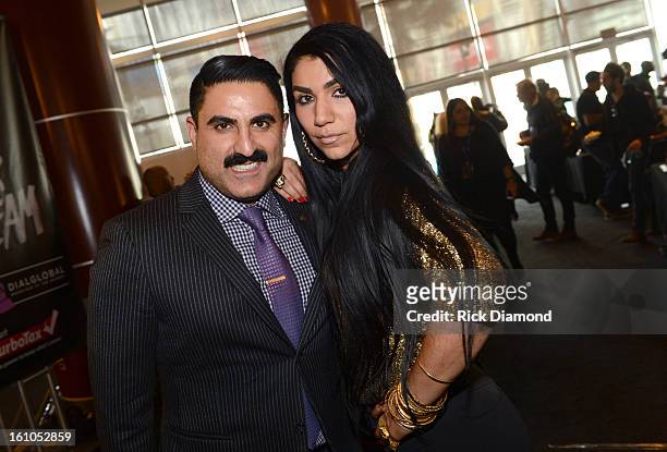 Reza Farahan and Asa Soltan Rahmati pose backstage at the GRAMMYs Dial Global Radio Remotes during The 55th Annual GRAMMY Awards at the STAPLES...