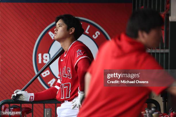 Shohei Ohtani of the Los Angeles Angels looks on with his bat in the dugout during the first inning of a game against the San Francisco Giants at...