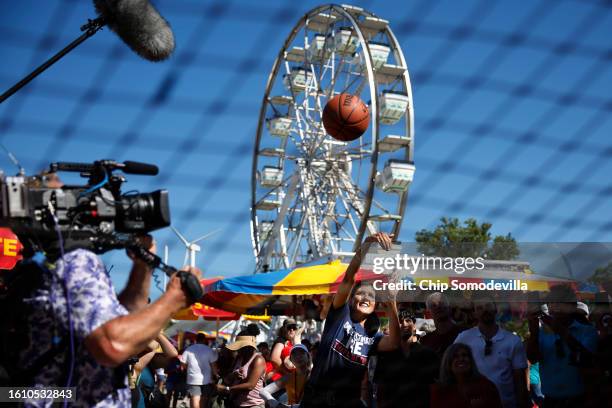 Former South Carolina Governor, ambassador to the United Nations, and Republican presidential candidate Nikki Haley plays carnival games at the Iowa...