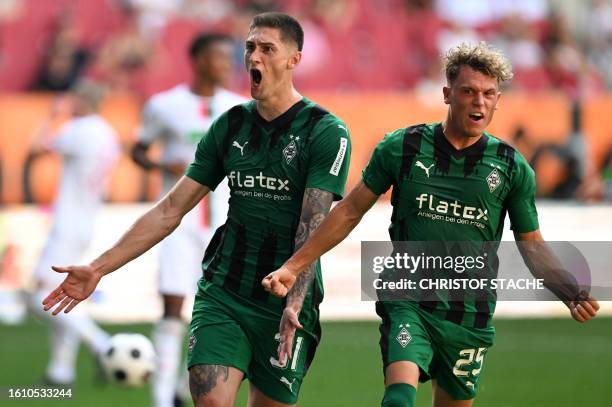 Moenchengladbach's Czech forward Tomas Cvancara celebrates scoring a penalty with his teammate German midfielder Robin Hack during German first...