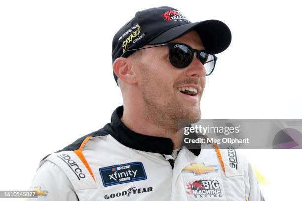 Parker Kligerman, driver of the Spiked Light Coolers Chevrolet, walks backstage during pre-race ceremonies prior to the NASCAR Xfinity Series...