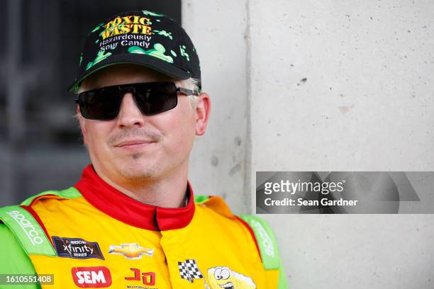 Brennan Poole, driver of the Toxic Waste Hazardously Sour Candy Chevrolet, waits backstage during pre-race ceremonies prior to the NASCAR Xfinity...