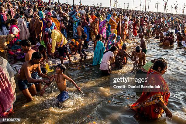 Hindu devotees bathe on the banks of Sangam, the confluence of the holy rivers Ganges, Yamuna and the mythical Saraswati, during the Maha Kumbh Mela...
