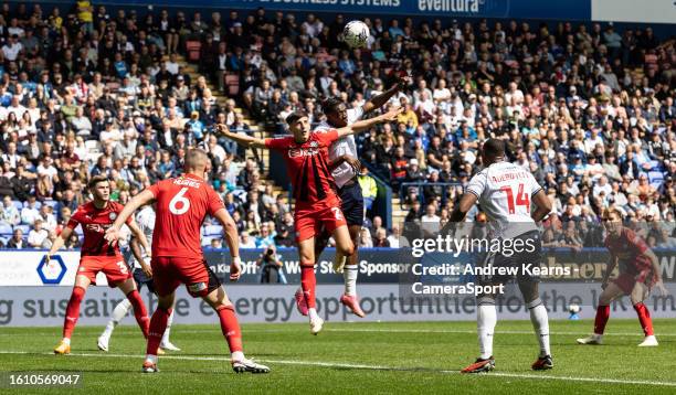 Bolton Wanderers' Dan N'Lundulu competing in the air with Wigan Athletic's Kelland Watts during the Sky Bet League One match between Bolton Wanderers...