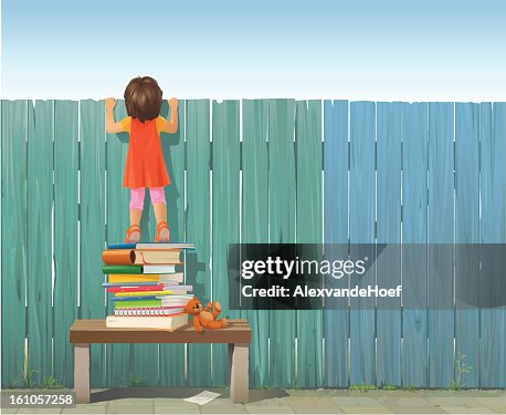 Schoolgirl on pile of books looking over fence Schoolgirl on pile of books looking over fence