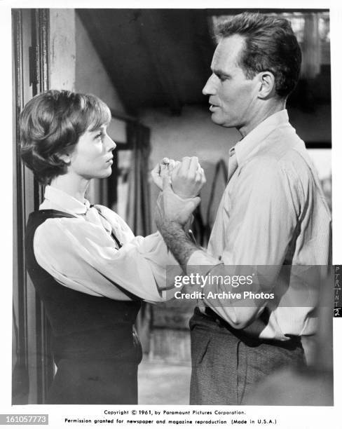 Elsa Martinelli is held by Charlton Heston in a scene from the film 'The Pigeon That Took Rome', 1962.
