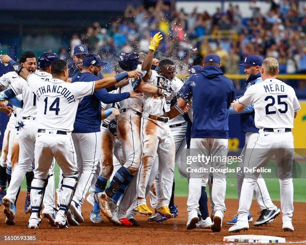 Randy Arozarena of the Tampa Bay Rays celebrates with teammates after hitting a walk-off RBI single during the ninth inning against the Cleveland...