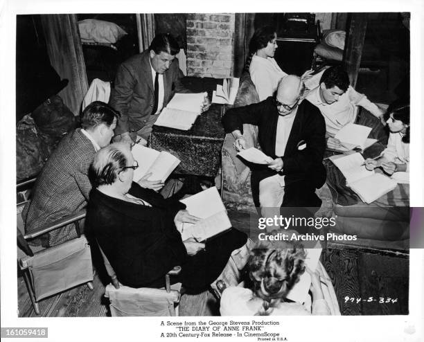 Joseph Schildkraut, Millie Perkins and the rest of the cast read their scripts on set of the film 'The Diary Of Anne Frank', 1959.