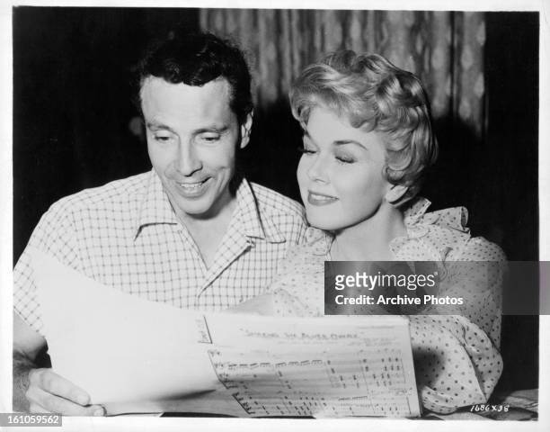 Choreographer Alex Romero goes over a musical number with Doris Day on set of the film 'Love Me Or Leave Me', 1955.