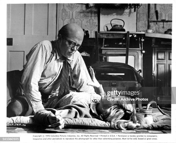Richard Attenborough attends to Judy Geeson in a scene from the film '10 Rillington Place', 1971.